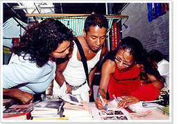 Visitors of a Pasar recognize relatives in old photographs at the MHM information booth