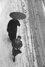 Winter: people in the snow with an umbrella